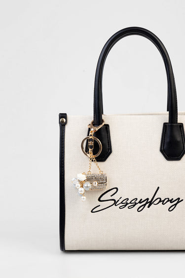 beige canvas handbag with black handles and trim, gold bling charm with pearls attached