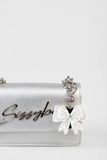 silver handbag with chain strap and a white sequined bow charm featuring a blue gemstone