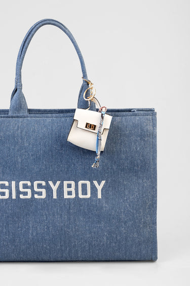 blue denim tote with bold white lettering and a small white attachable pouch with a gold clasp and scarf accessory
