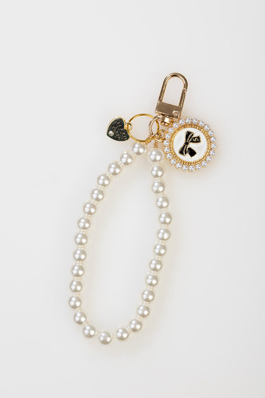 pearl beaded bag charm with gold hardware and a round pendant by Blue Jean Traders featuring a bow and tiny pearls