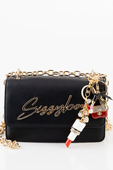 black leather bag with a chunky gold chain and assorted charms including a lipstick charm