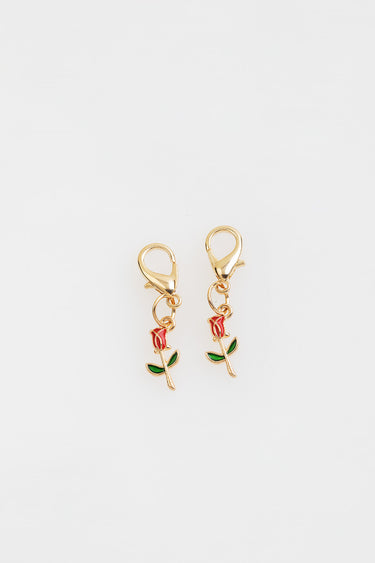 gold tone rose charm earrings with red petals and green leaves on small clasps