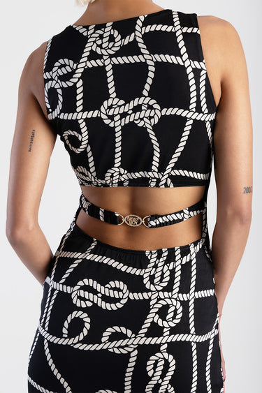 model wearing a black rope print sleeveless dress with a matching belt at the waist