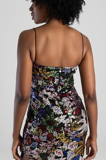 woman wearing a multicolor sequined dress with thin straps back view