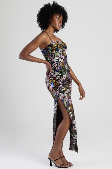 model wearing a multicolor sequin floral maxi dress with thin straps and a high side slit