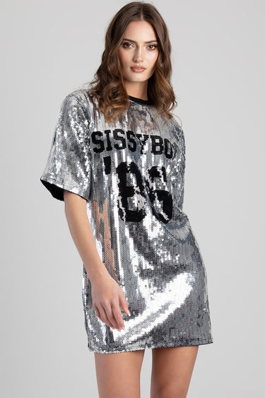 woman in a metallic silver sequin oversized t shirt dress with short sleeves and a bold black graphic print
