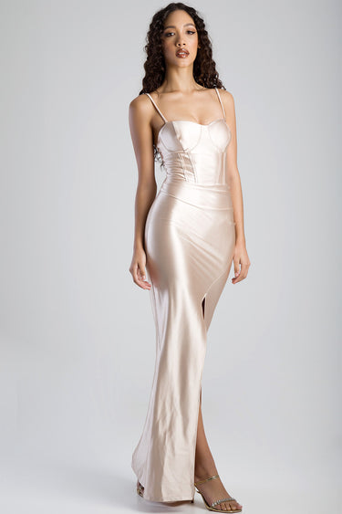 model wearing champagne satin corset dress with thin straps, structured bodice, fitted waist and thigh slit by Blue Jean