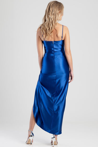 woman in royal blue satin maxi dress with spaghetti straps, back zipper, fitted bodice and a side slit, silver heels