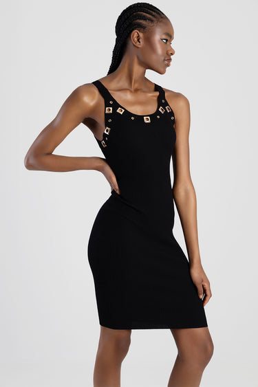 black knit sleeveless dress with gold square studs around the neckline and straps on a model