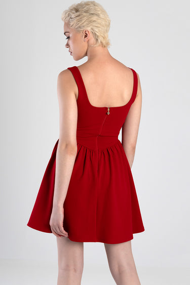 woman in red sleeveless dress with a square back, visible back zipper and gathered waist