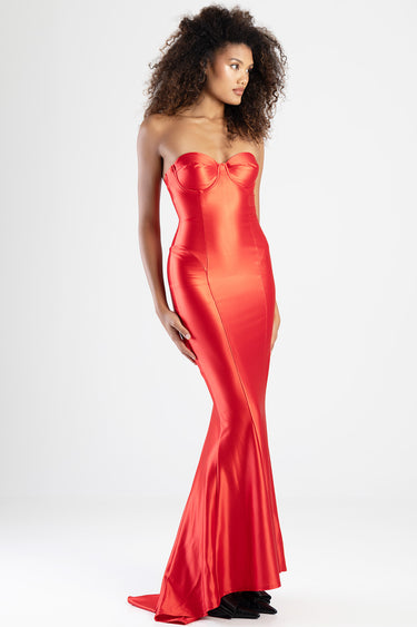 woman wearing a red satin strapless mermaid dress with a sweetheart neckline and fitted silhouette, floor length