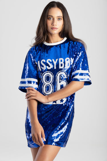 woman in a royal blue sequin dress with a white crew neck and white striped sleeves