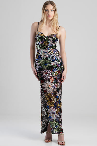 woman in a multicolour sequin floral maxi dress with thin straps and a side slit
