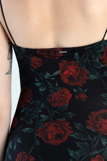 back view of a black dress with red rose print and thin straps