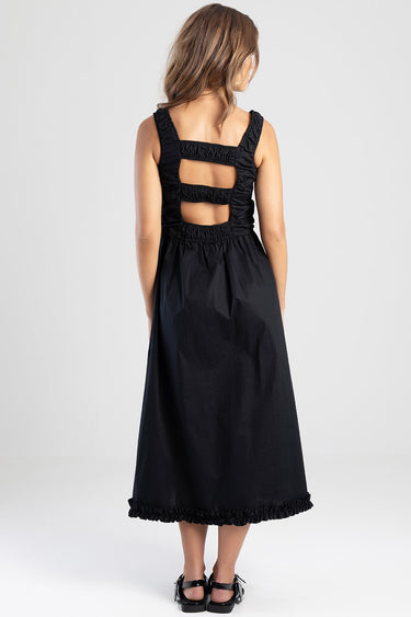 back view of black midi dress with ruched straps and three back cutouts ankle length with a frilled hem