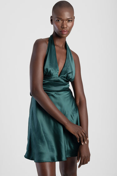 Blue Jean Traders satin halter mini dress on a model with a deep plunge neckline and wrapped waist