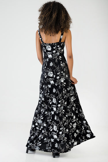 black maxi dress with white floral pattern, back view, wide shoulder straps, flowing hem