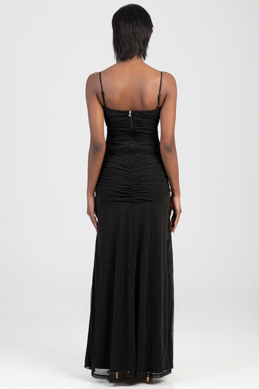 back view of a woman in a shimmering black maxi dress with thin straps and a center back zipper