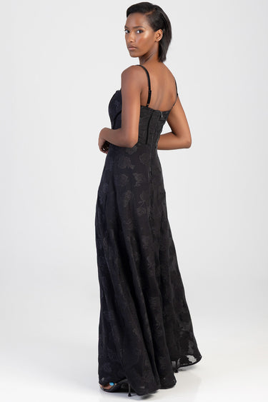 woman in a black lace maxi dress with a corset back and slender straps, full length silhouette