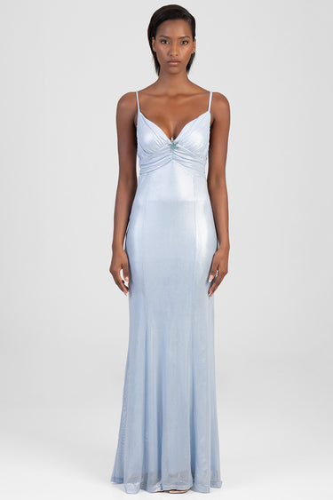 woman in a light blue maxi dress with thin straps, a ruched sweetheart bodice with a center jewel, and a flowing