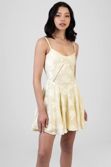 cream lace mini dress with delicate floral pattern and thin spaghetti straps on a model