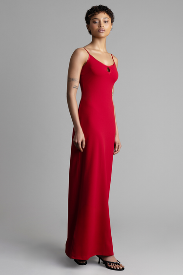 model in a red sleeveless maxi dress with a small keyhole neckline and thin straps, standing in black sandals