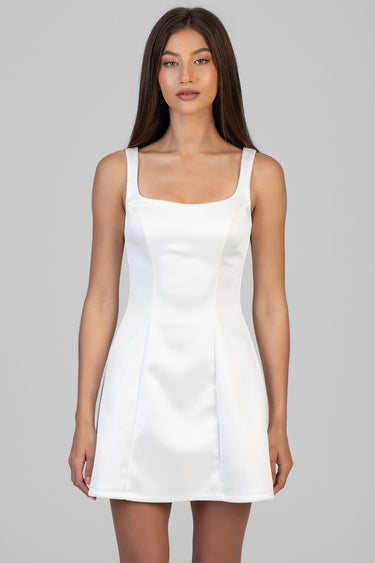 white mini dress with square neckline and broad straps, fitted bodice with vertical panels and a line skirt