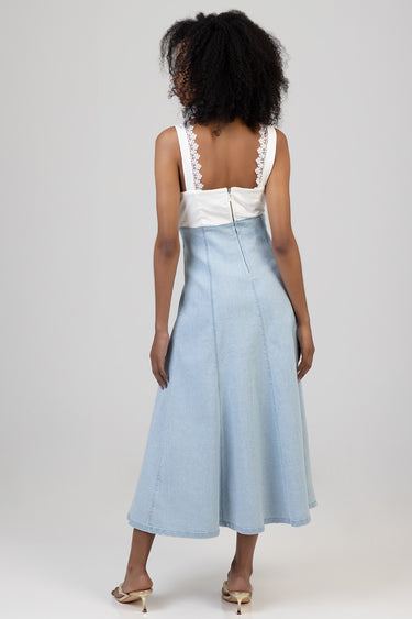 back view of a woman in a light denim midi dress with lace trimmed straps and a back zipper
