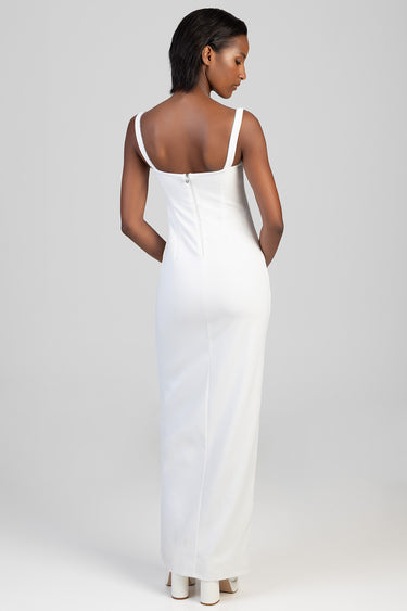 woman in white sleeveless maxi dress with wide straps and back zipper, fitted silhouette, floor length