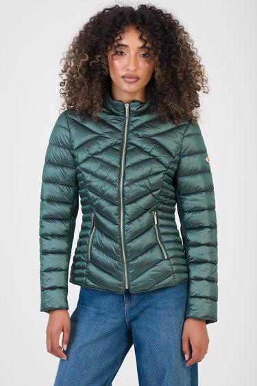 woman in a teal green puffer jacket with chevron quilting, stand collar, silver front zip and zip pockets