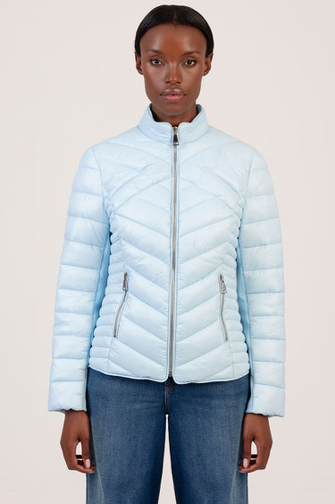 light blue quilted puffer jacket with a stand collar, full front zipper and zip pockets on a model