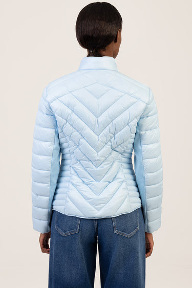 back view of a light blue quilted puffer jacket with chevron stitching and a standing collar