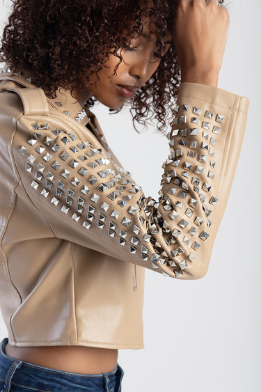 beige studded leather jacket with metallic pyramid studs on sleeves, cropped fit