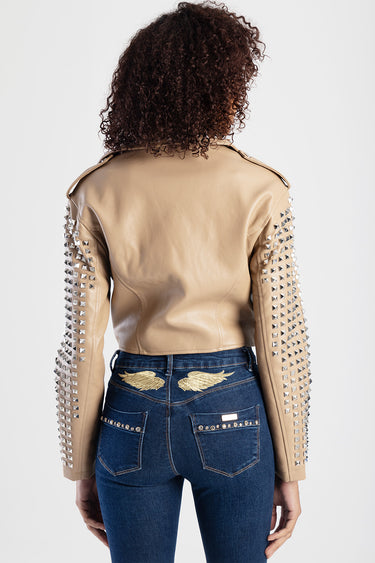 tan leather jacket with silver pyramid studs along the sleeves and shoulder epaulettes, back view; blue jeans with gold