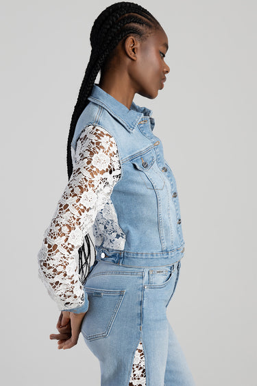 side view of a woman wearing a light blue denim jacket with white lace sleeves