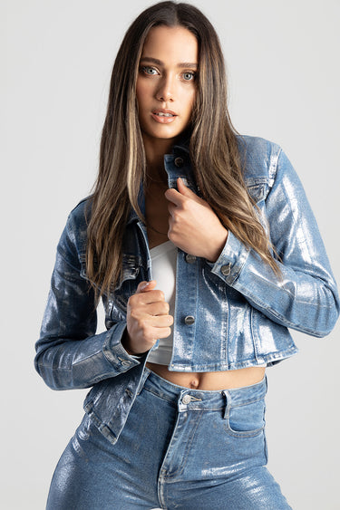 woman wearing a cropped metallic blue denim jacket and matching jeans by Blue Jean Traders