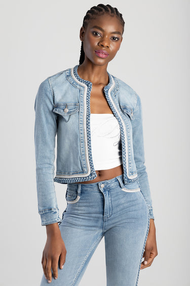 woman wearing a light wash cropped denim jacket with braided trim and front pockets with matching jeans
