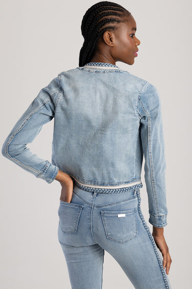 back view of light blue denim jacket with braided trim at hem and collar, paired with matching jeans