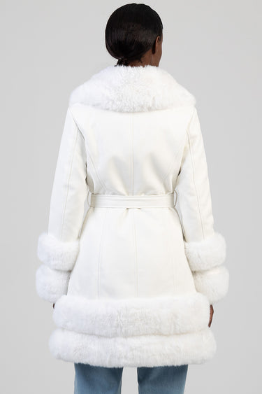 back view of a white faux fur trimmed coat with a wide collar belted waist and fluffy cuffs and hem by blue jean traders