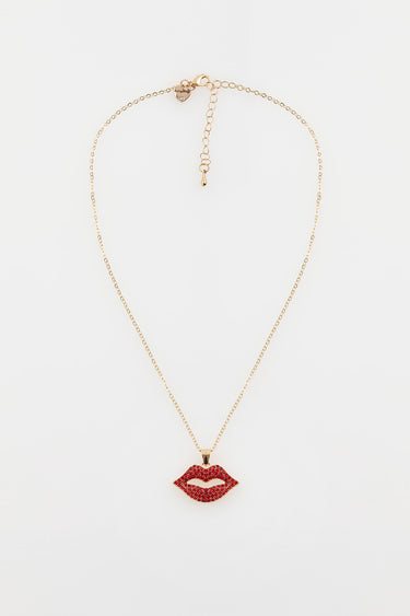 gold tone lip shaped pendant encrusted with red stones on a delicate chain with extender