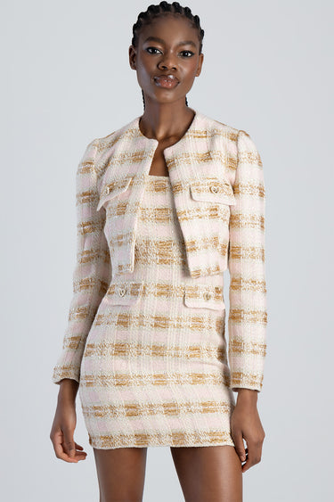 model wearing a pink and beige tweed jacket with a matching mini skirt from Blue Jean Traders.