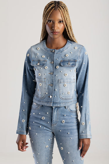 blue denim jacket with pearl bead embellishments and chest pockets worn by a model