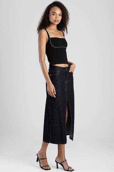 model wearing a black sleeveless crop top with a dark wash denim midi skirt featuring a front slit and contrast stitching