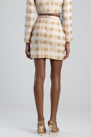 back view of a pink and beige tweed mini skirt with a center back zipper