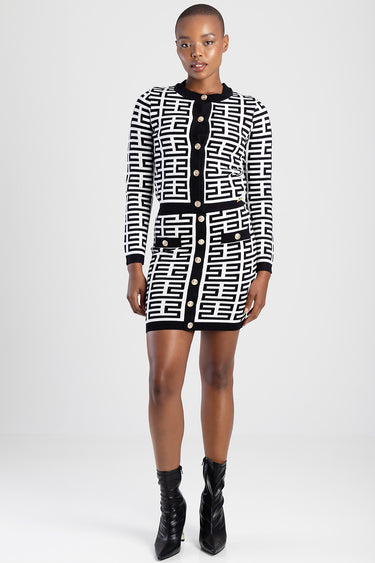 Blue Jean Traders knit dress with black and white geometric pattern, gold buttons and belt, knee length, black ankle boots