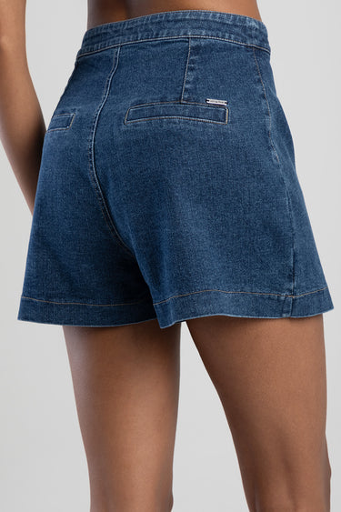 blue denim skort shown from behind with rear pockets and a small metal tag