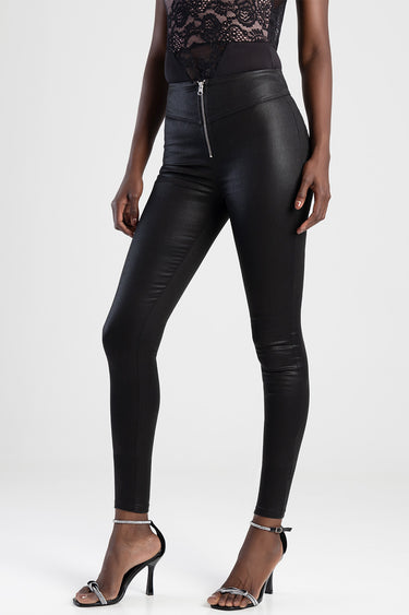woman wearing high waist black faux leather pants with a front metallic zipper and strappy heels