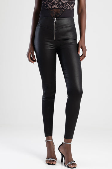 woman wearing blue jean traders faux leather pants with a high waist and front zipper, paired with lace top and silver heels