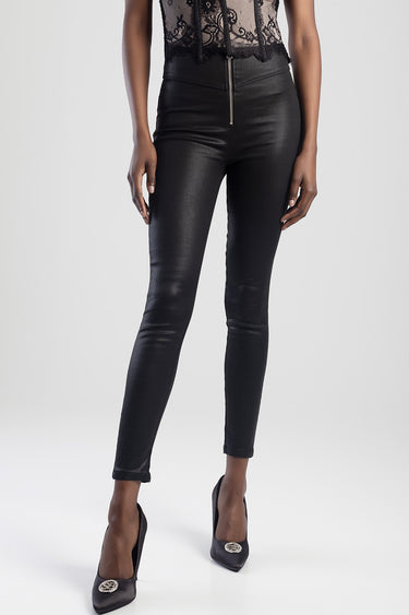 woman in high waist black faux leather pants with a front zipper and pointed toe heels