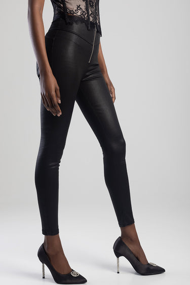woman wearing black faux leather pants with a front zip and heels; lace top visible